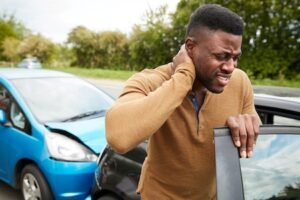 male holding his neck due to an auto accident injury to his neck