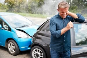 man holding his neck due too auto accident