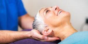 chiropractor holding a female patients head