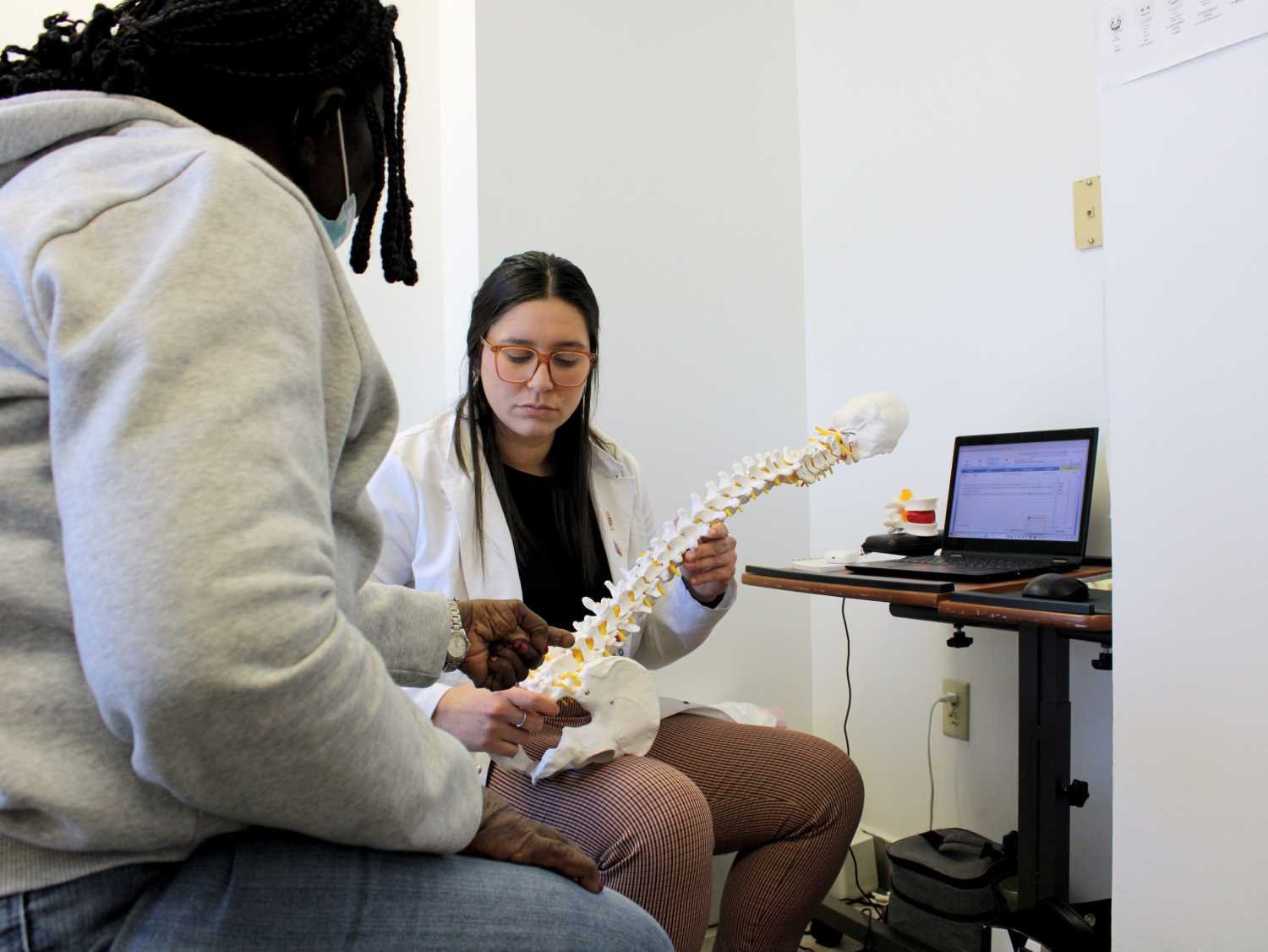 Dr. Ashley Explaining Patient the Benefits of Chiropractic care